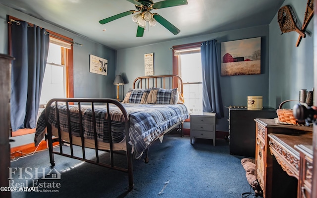 bedroom with dark colored carpet and ceiling fan