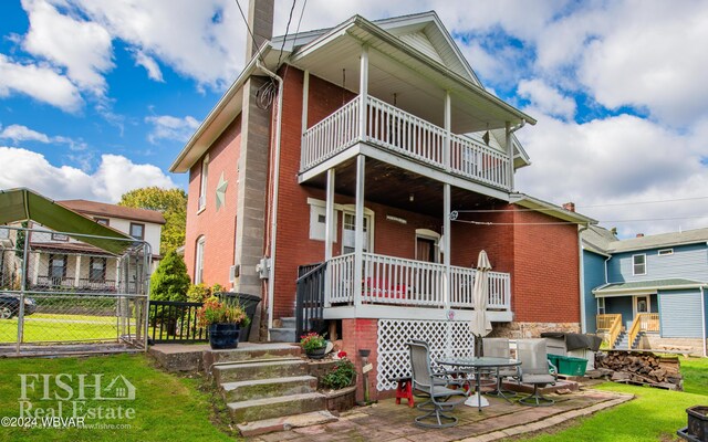 back of property featuring a patio area and a balcony