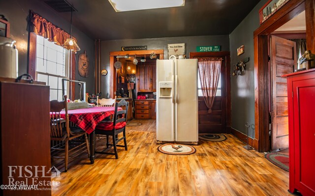 dining area with plenty of natural light and light hardwood / wood-style floors