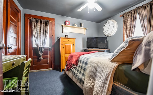 bedroom featuring multiple windows, ceiling fan, and dark colored carpet