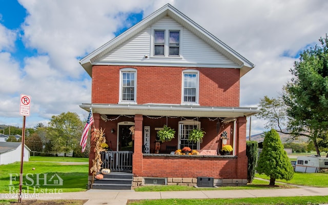 view of front of house with covered porch, central AC, and a front lawn