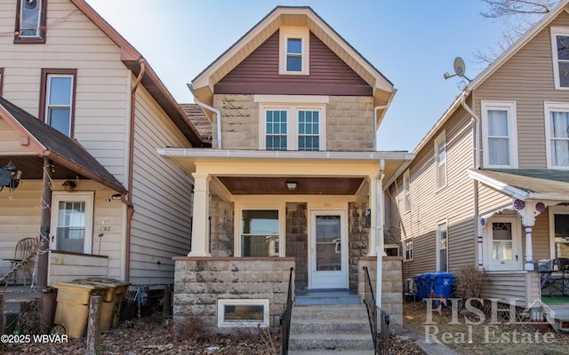 view of front facade featuring stone siding and a porch