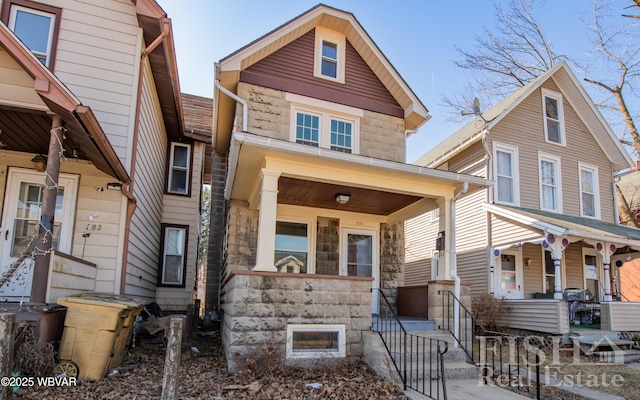 view of front of house with stone siding and covered porch