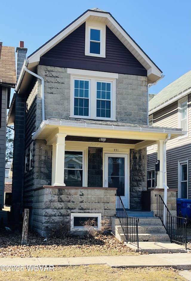 view of front facade featuring stone siding and covered porch