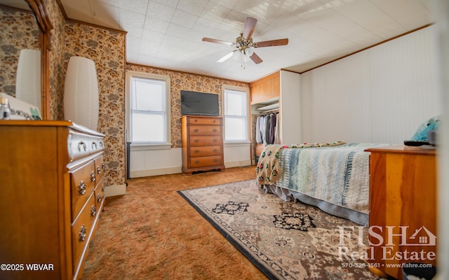 carpeted bedroom featuring a closet, ceiling fan, and ornamental molding