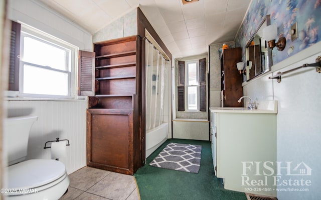 full bathroom with toilet, shower / bath combination, tile patterned floors, vanity, and vaulted ceiling