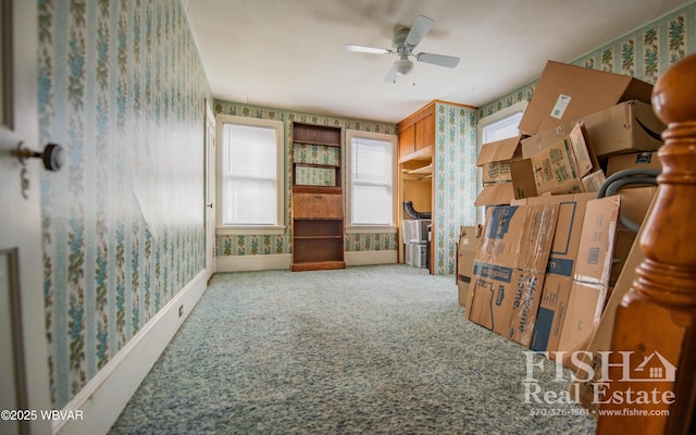 interior space with ceiling fan