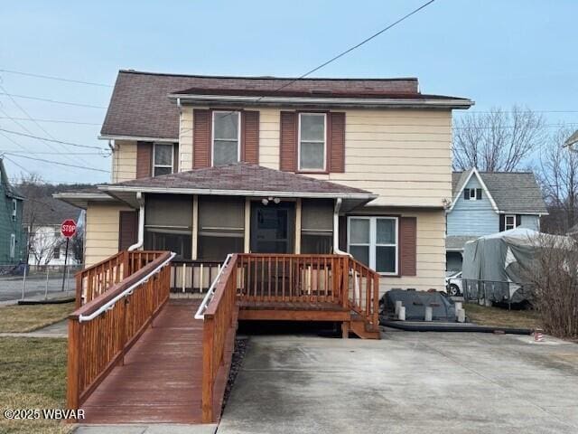 view of front of home featuring a sunroom