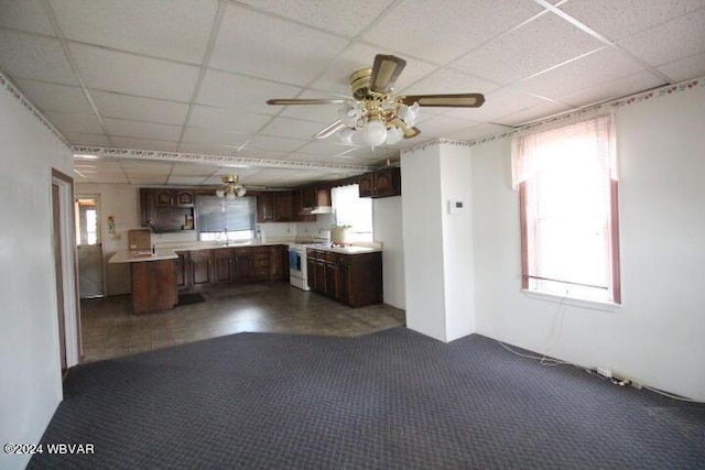 kitchen featuring a paneled ceiling, sink, carpet floors, dark brown cabinetry, and electric stove