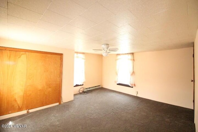 carpeted empty room with a baseboard radiator and ceiling fan