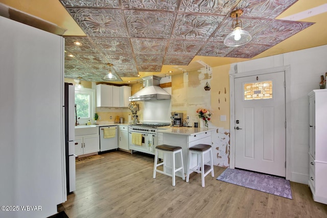 2177 N Williamson Rd, Covington, PA 16917 - kitchen with wall chimney range hood, white appliances, an ornate ceiling, light wood finished floors, and light countertops