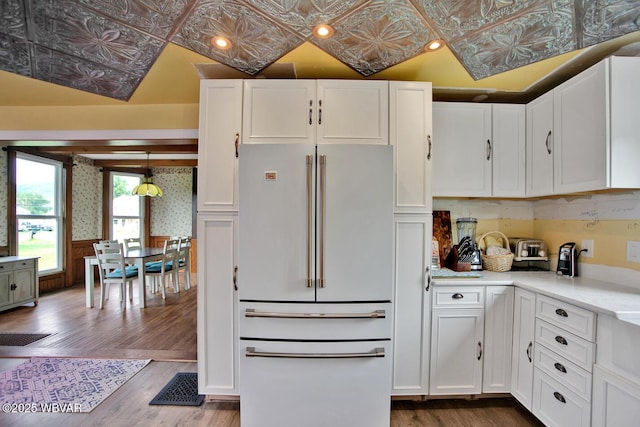 2177 N Williamson Rd, Covington, PA 16917 - kitchen with white refrigerator, an ornate ceiling, white cabinets, wood finished floors, and light countertops