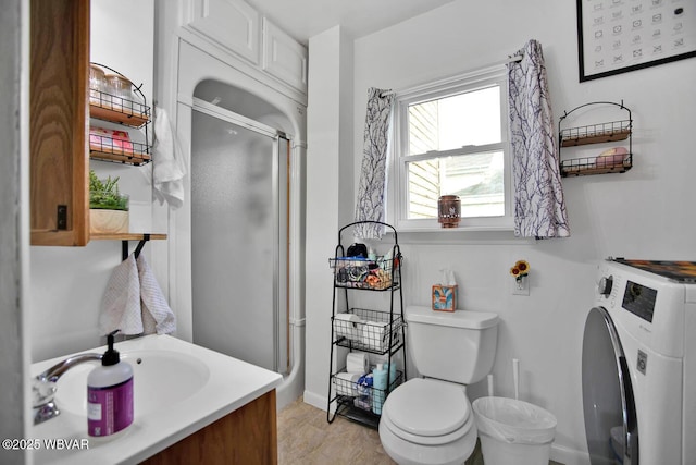 2177 N Williamson Rd, Covington, PA 16917 - bathroom featuring washer / dryer, a shower stall, toilet, vanity, and baseboards