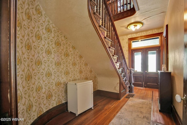 2177 N Williamson Rd, Covington, PA 16917 - foyer entrance with wood finished floors, wallpapered walls, stairs, and baseboards