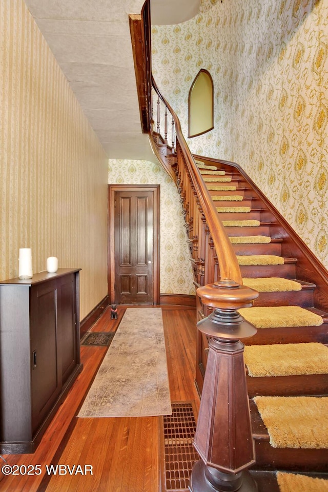2177 N Williamson Rd, Covington, PA 16917 - stairway with wallpapered walls, wood-type flooring, and baseboards