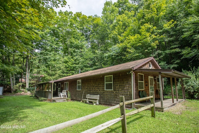 exterior space with a yard and a sunroom