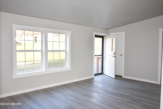 empty room with dark wood-type flooring