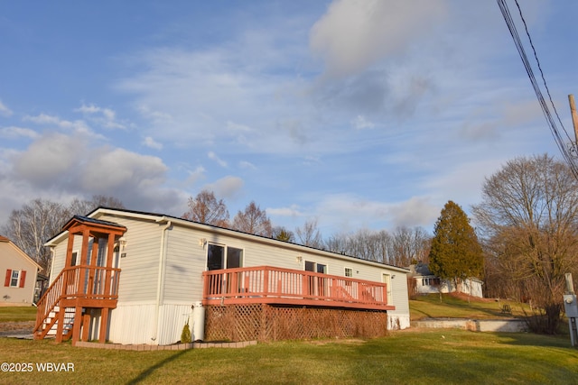 rear view of property with a deck and a lawn