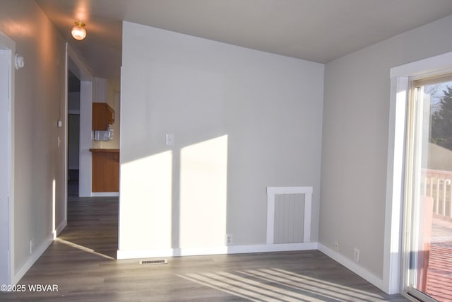 unfurnished room featuring dark hardwood / wood-style floors