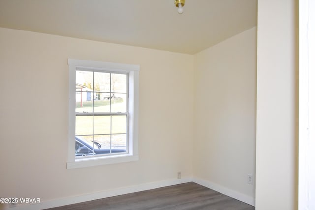 unfurnished room with dark wood-type flooring