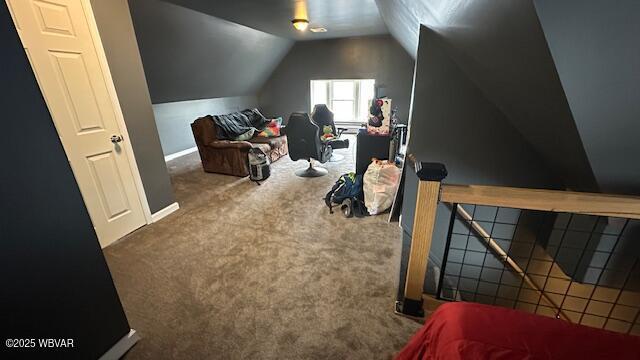 additional living space featuring lofted ceiling and carpet flooring