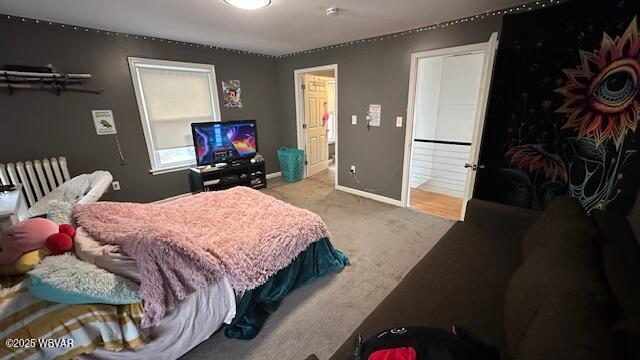 bedroom with light carpet and baseboards