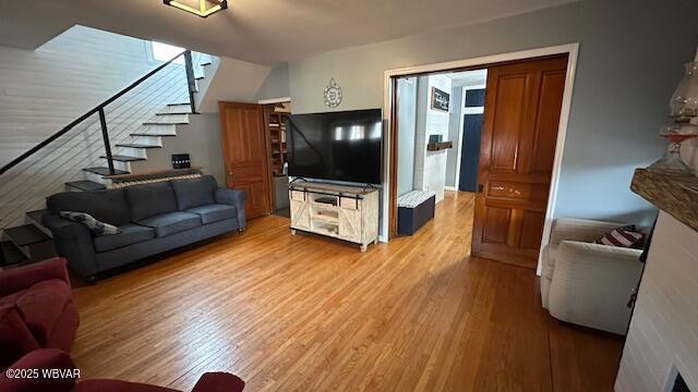 living area featuring light wood-style floors and stairs