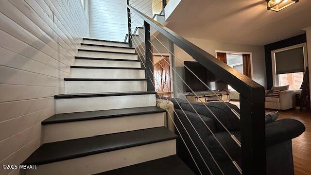 stairway featuring wood finished floors