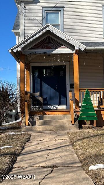 view of exterior entry featuring a porch