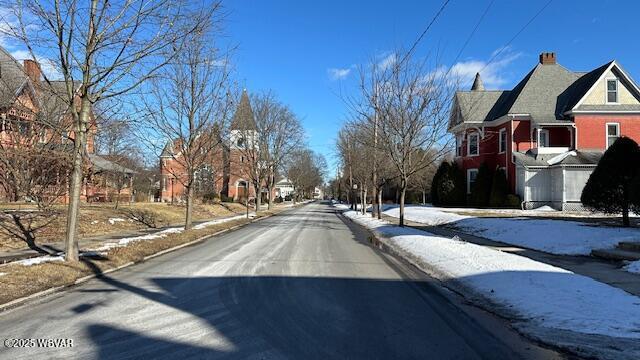 view of road featuring sidewalks, a residential view, and curbs