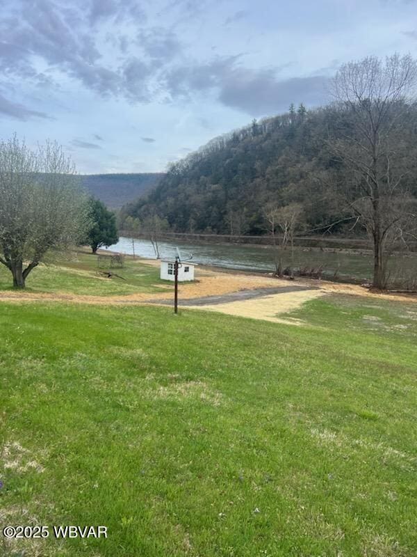 surrounding community featuring a yard and a water and mountain view