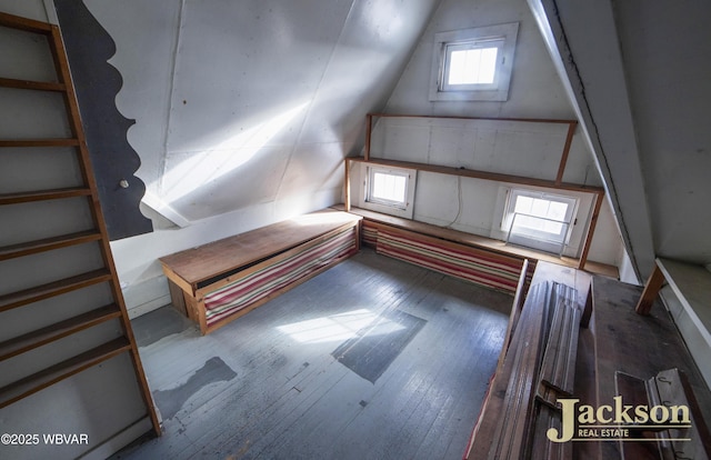 bonus room with hardwood / wood-style floors and vaulted ceiling