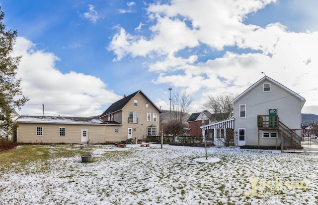 view of snow covered rear of property