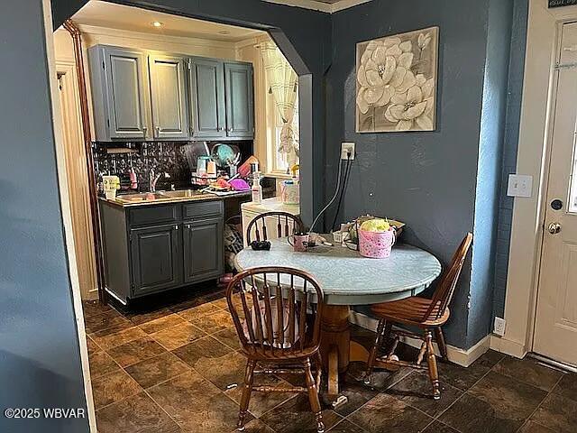 1518 Memorial Ave, Williamsport, PA 17701 - dining room with baseboards, arched walkways, ornamental molding, and dark stone finish floors