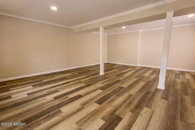 finished basement featuring baseboards, dark wood-type flooring, recessed lighting, and crown molding