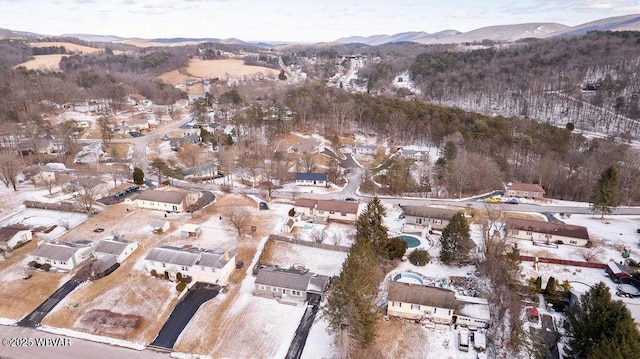 snowy aerial view with a residential view and a mountain view