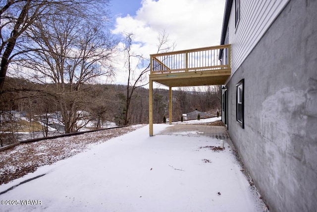 yard layered in snow featuring a wooden deck