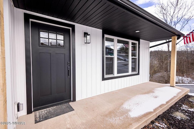 view of snow covered property entrance