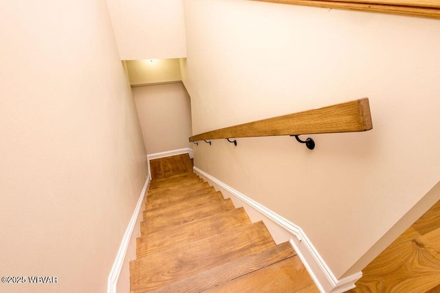 stairs with baseboards and wood finished floors