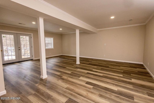 basement with ornamental molding, french doors, dark wood-type flooring, and baseboards