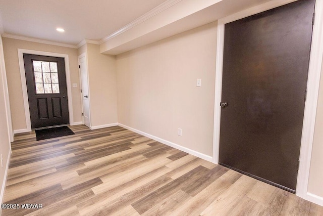 foyer entrance with ornamental molding, recessed lighting, wood finished floors, and baseboards