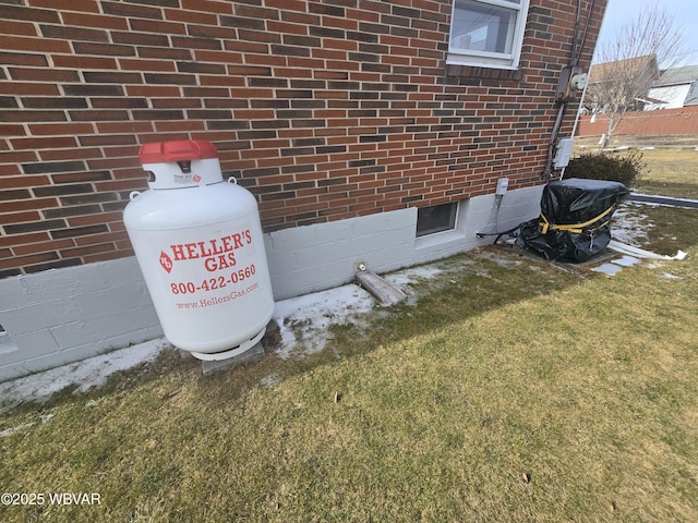 details featuring heating fuel and brick siding