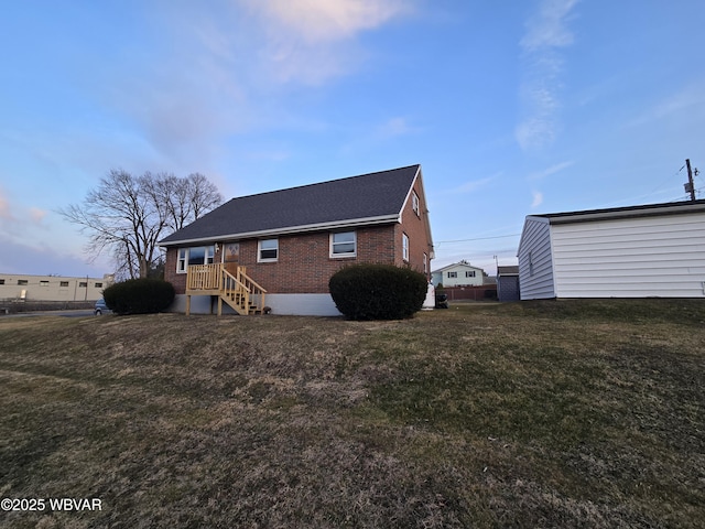 exterior space with a yard and brick siding