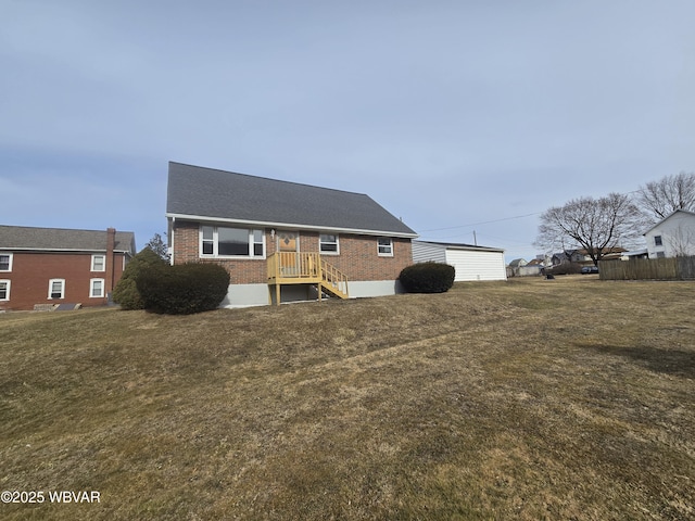 view of front of property featuring a front yard and brick siding