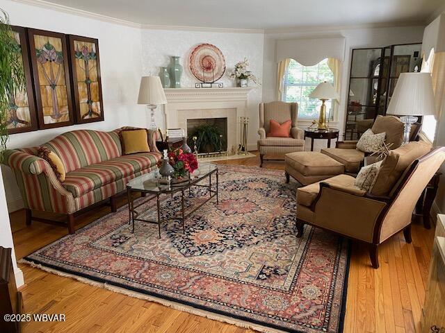 1550 Campbell St, Williamsport, PA 17701 - living area featuring crown molding, a fireplace with flush hearth, and wood finished floors