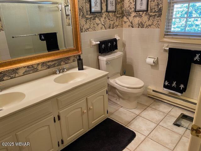 1550 Campbell St, Williamsport, PA 17701 - bathroom featuring wallpapered walls, wainscoting, a sink, and a baseboard radiator