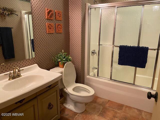 1550 Campbell St, Williamsport, PA 17701 - full bath with vanity, tile patterned floors, bath / shower combo with glass door, toilet, and wallpapered walls