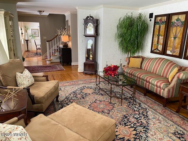 1550 Campbell St, Williamsport, PA 17701 - living area featuring stairs, crown molding, baseboards, and wood finished floors