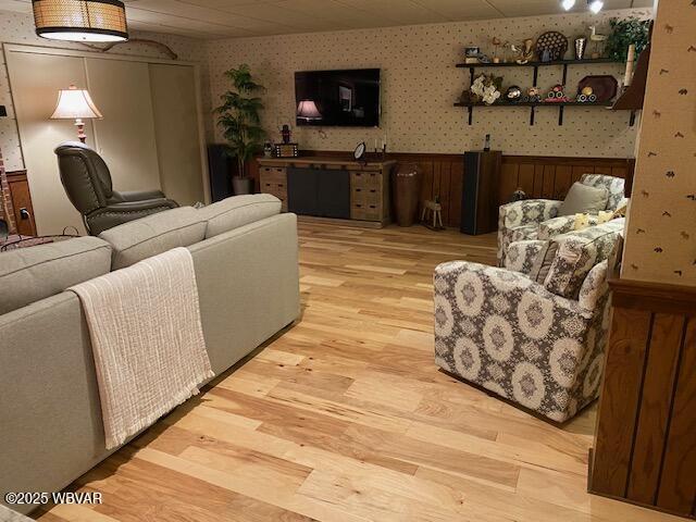 1550 Campbell St, Williamsport, PA 17701 - living area featuring wallpapered walls, wainscoting, and light wood-style floors