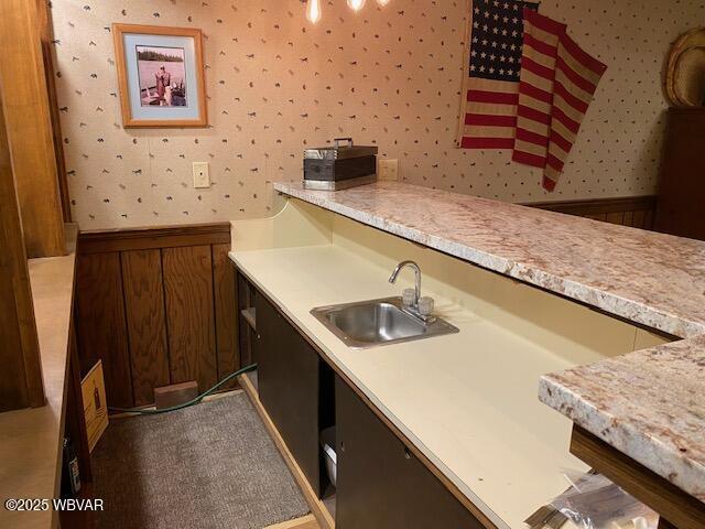 1550 Campbell St, Williamsport, PA 17701 - kitchen featuring light countertops, a sink, and wallpapered walls